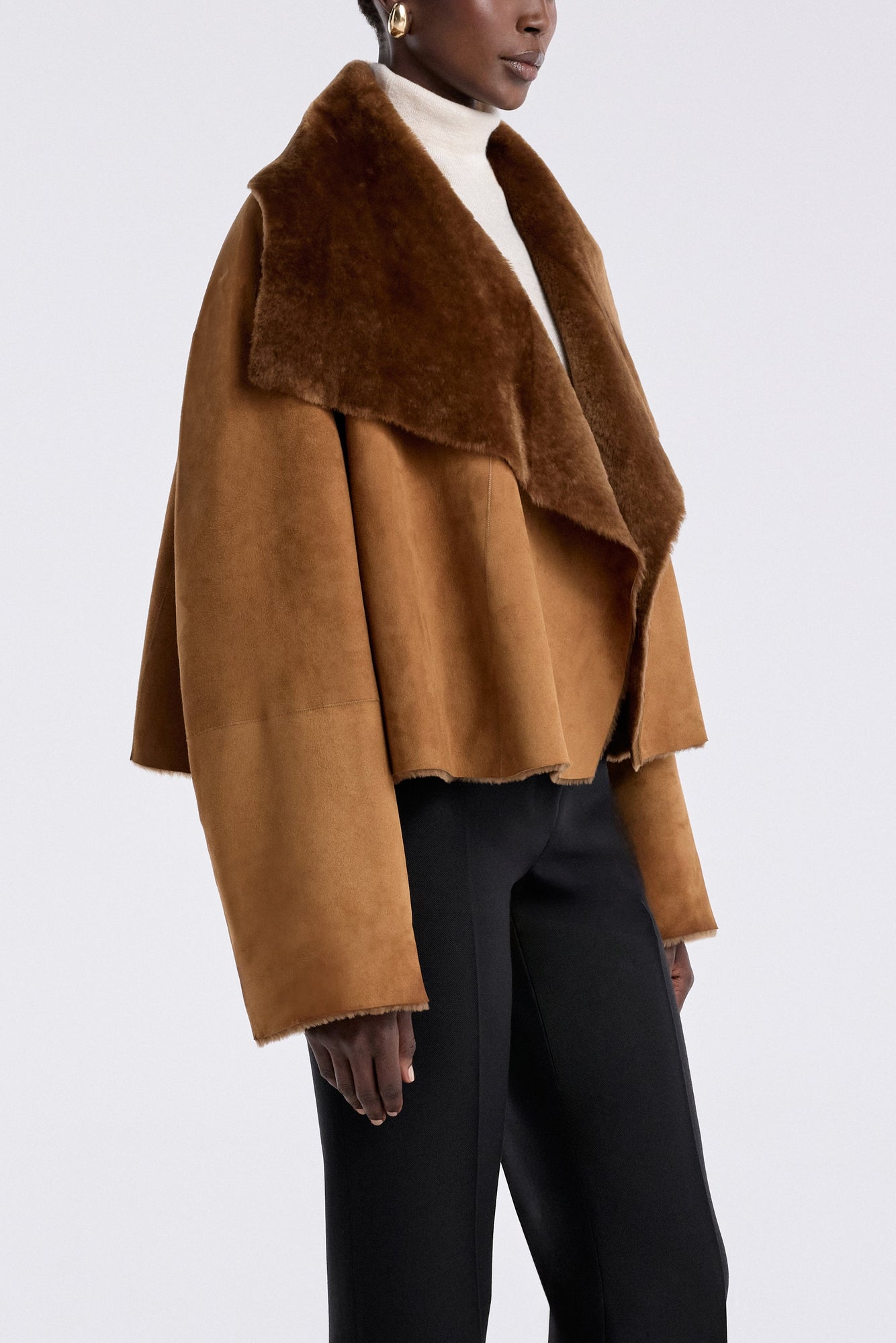 Model is wearing the Nour Hammour Cascade Draped Shearling Jacket Marigold - Three Quarters