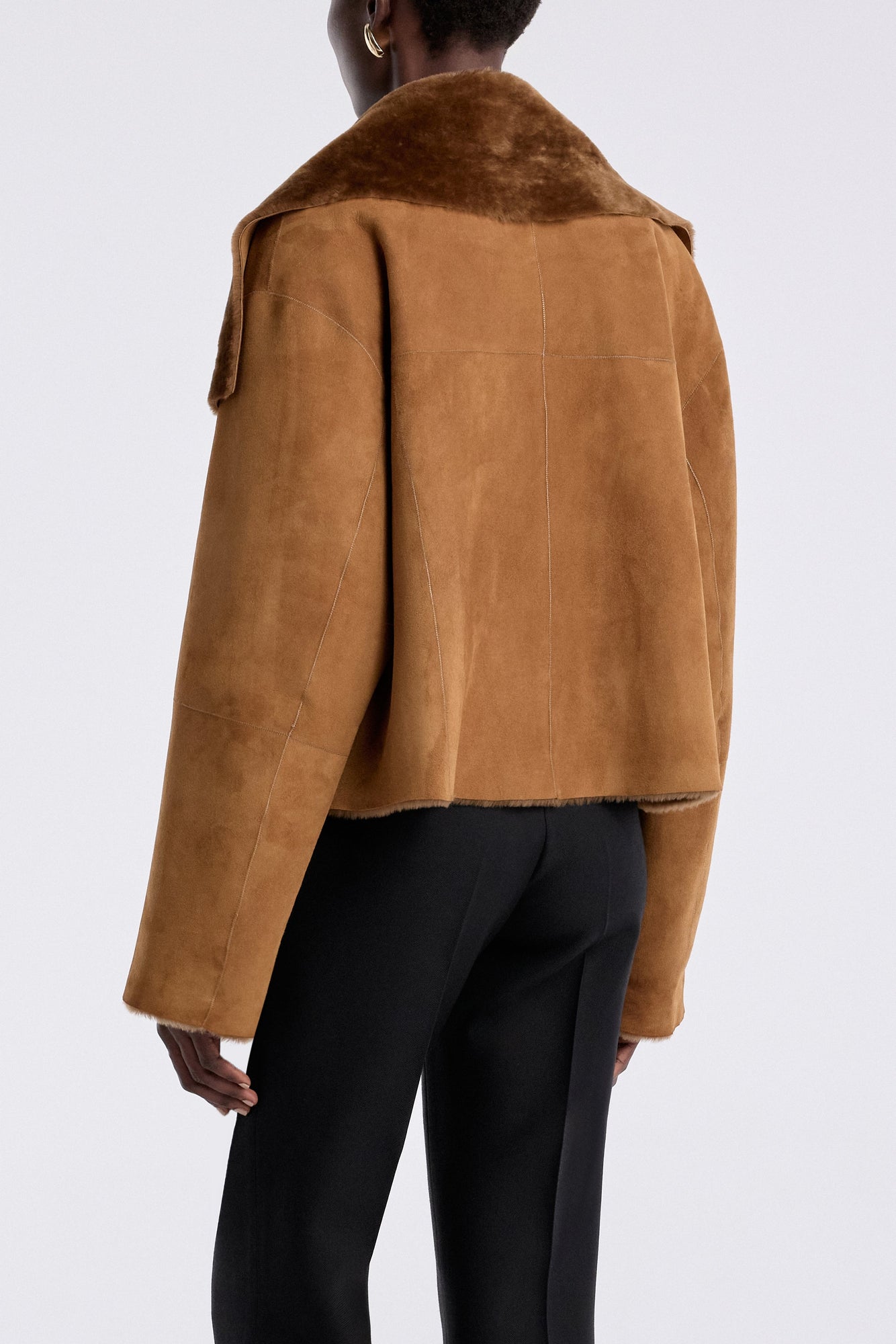 Model is wearing the Nour Hammour Cascade Draped Shearling Jacket Marigold - Back