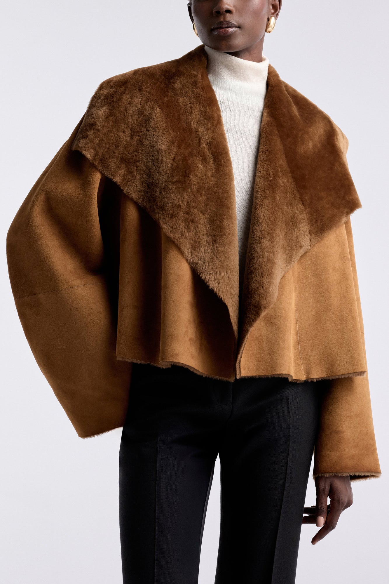 Model is wearing the Nour Hammour Cascade Draped Shearling Jacket Marigold - Detail