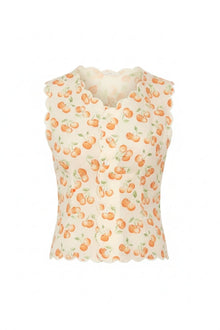 Cream sleeveless vest with orange cherry and green leaf print and scalloped neckline and armholes.