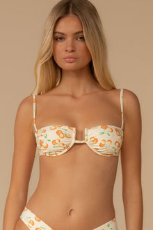 Cherry patterned bikini top with thin shoulder straps and underwire cups on cream background.