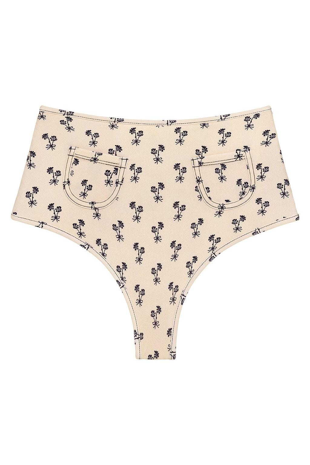 Cream bikini bottom with all-over black palm tree print and front patch pockets.