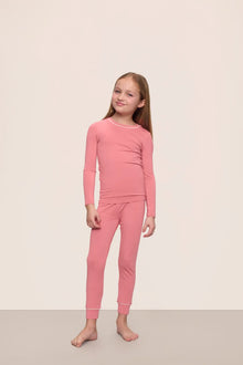 Model wearing Kids TENCEL Modal Unisex Long PJ Set in Sunkissed Coral/Ivory