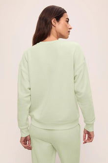Model is wearing French Terry Sweatshirt in Matcha