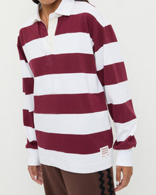 Evan Rugby Shirt in maroon and white striped cotton and Venus Track Pant in brown cotton.