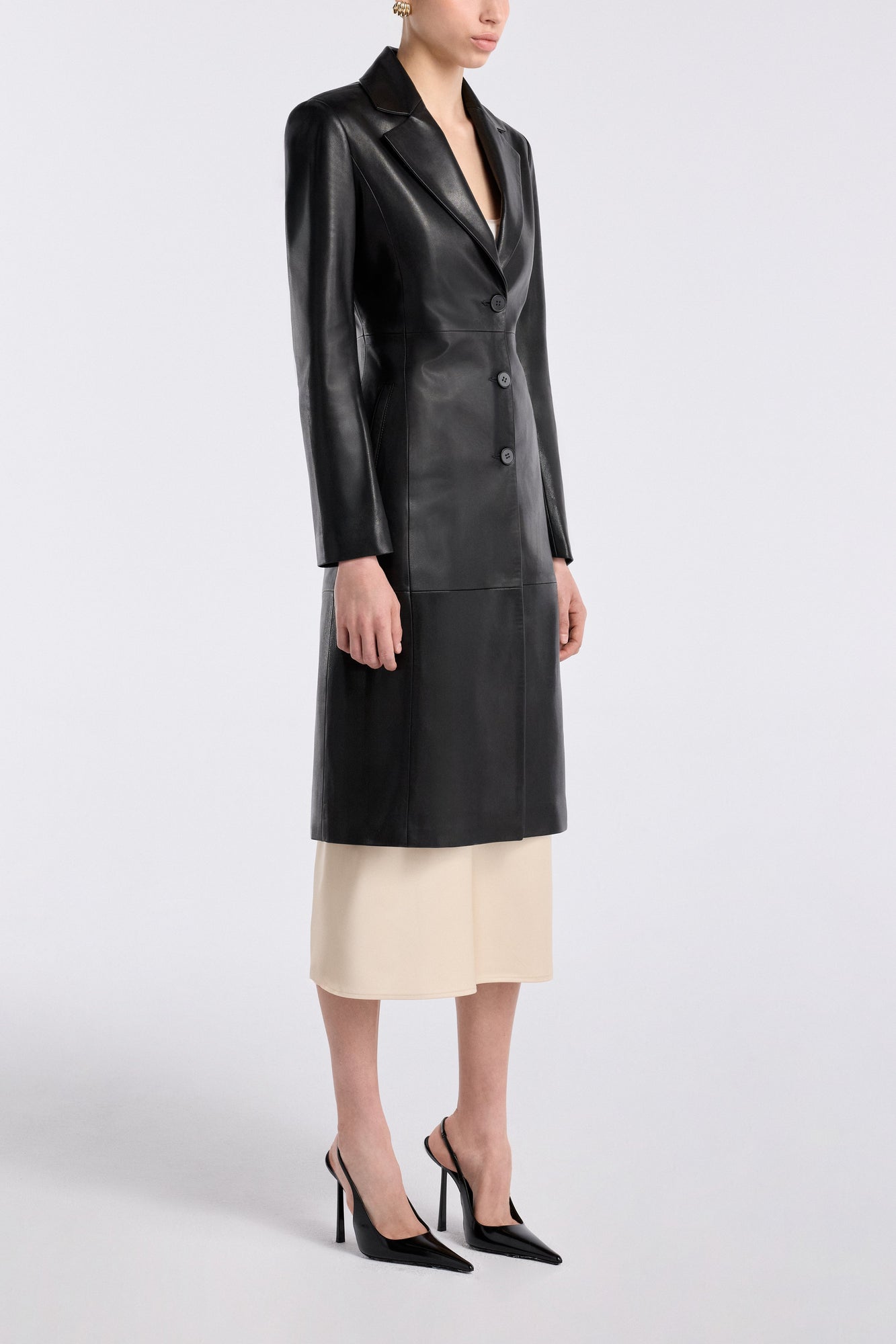 Model is wearing the Nour Hammour Eames Grand Leather Coat Black - Three Quarters