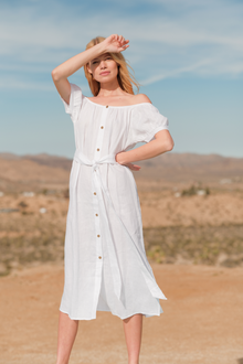 Model wears Harper Linen Dress in white.