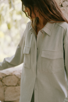 Model wears Luxe Sweats Shacket in botanical zen green.