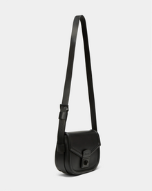 The ALORA - 8324506 Black by Rudsak is a premium leather crossbody bag with an adjustable strap, front flap closure, and rectangular buckle detail. Shown on a plain light background, it exudes timeless elegance.