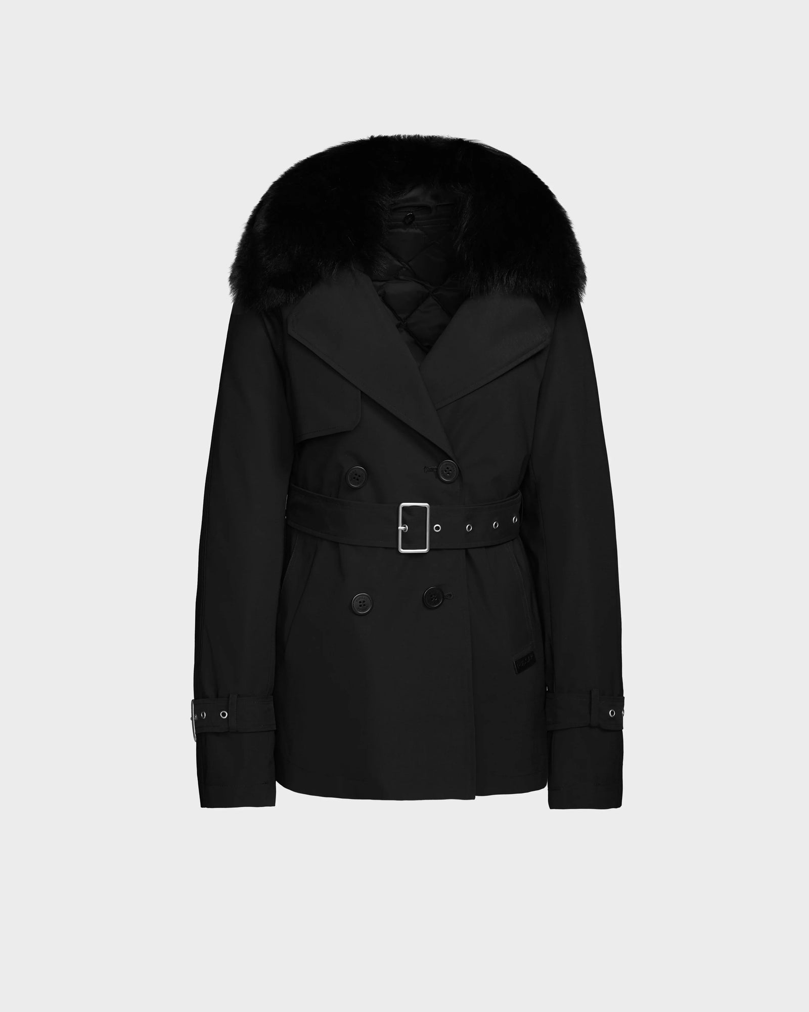 The ELENOR - 8124707 Black by Rudsak is a women’s trench coat featuring a wide belt, large lapels, button details, and a plush black shearling collar, shown against a plain light gray background.
