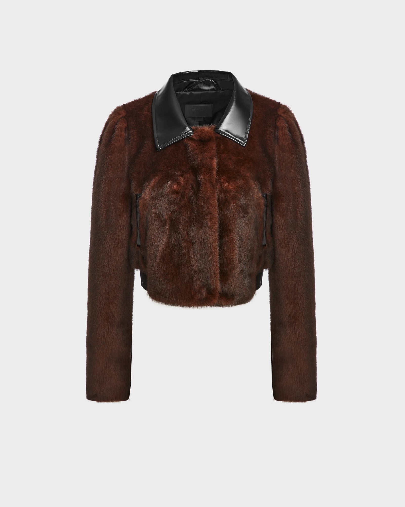 The EVELYN - 8124791 Espresso by Rudsak is a cropped, long-sleeve brown faux fur jacket with a black leather collar and two vertical zippered pockets, shown against a plain light background.