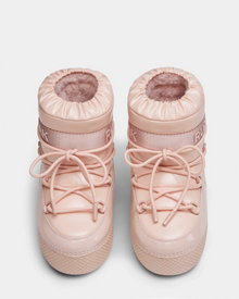 The HARLOW Y - 1223500 Pastel Pink kids boots by Rudsak feature light pink, fur lining, round toes, crisscross laces, rubber soles, and a thick ankle band—ideal weather-resistant footwear for winter adventures.
