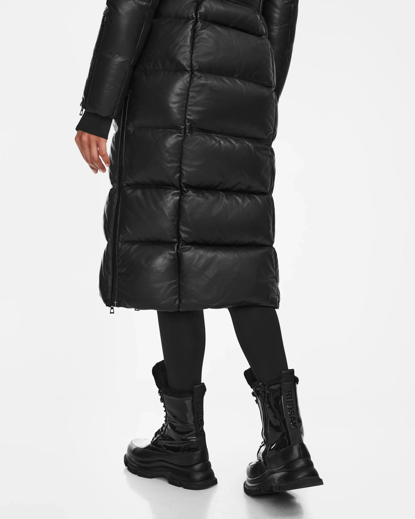 A person wearing the LANA - 8223506 BLACK coat by Rudsak and mid-calf lace-up boots.