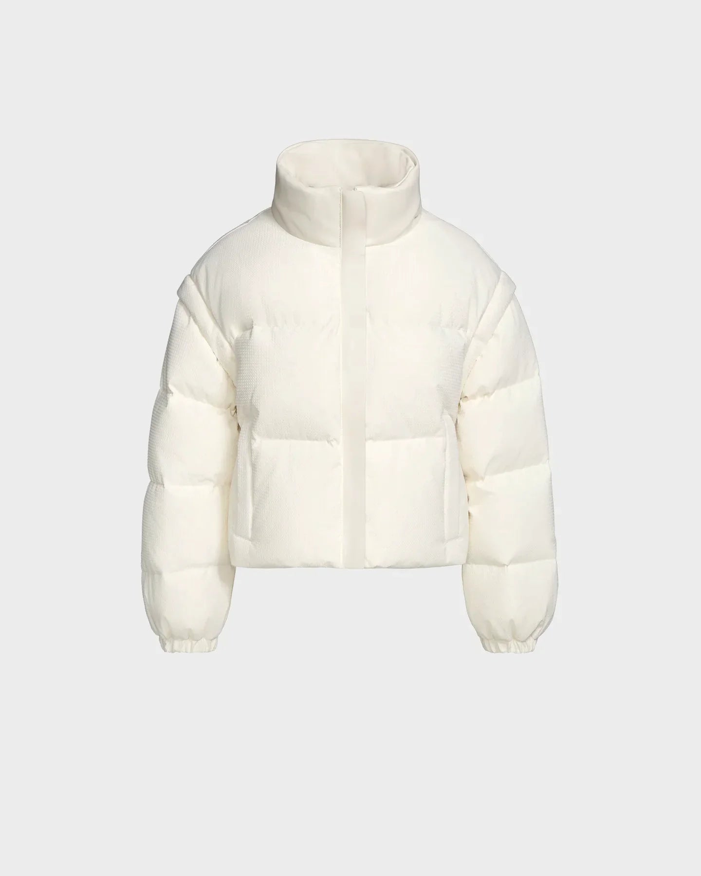 The Rudsak OPRAH - 8124708 Iceland is a womens cropped down puffer jacket with RDS certified ethical down, high collar, front zipper, elastic cuffs, and quilted design. Shown on a light gray background.