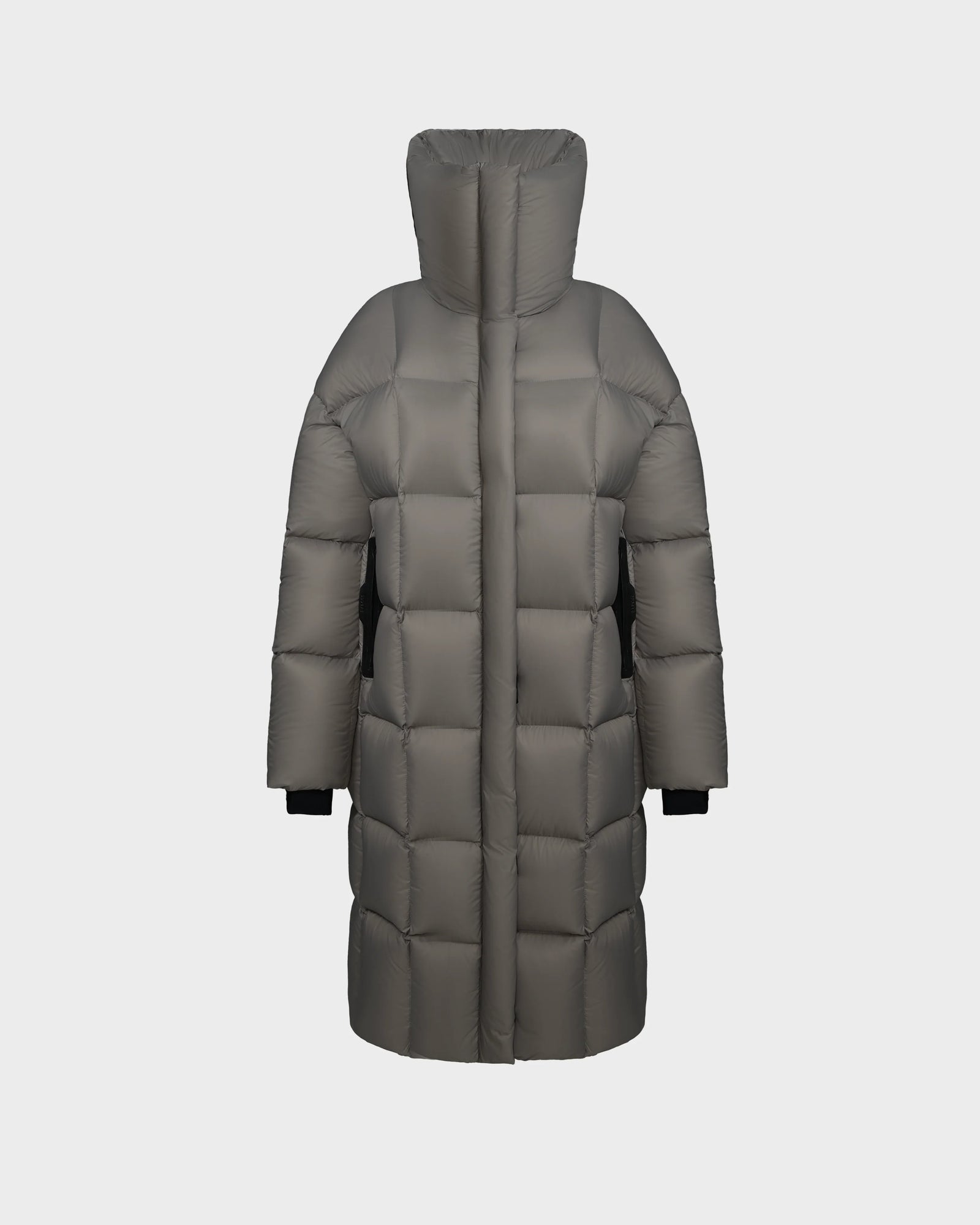 The Rudsak SASH - 8124536 Light Grey is a womens long down puffer coat with large quilted sections, a high collar, and black inner cuffs, displayed on a white background. This stylish winter coat offers exceptional warmth and comfort.