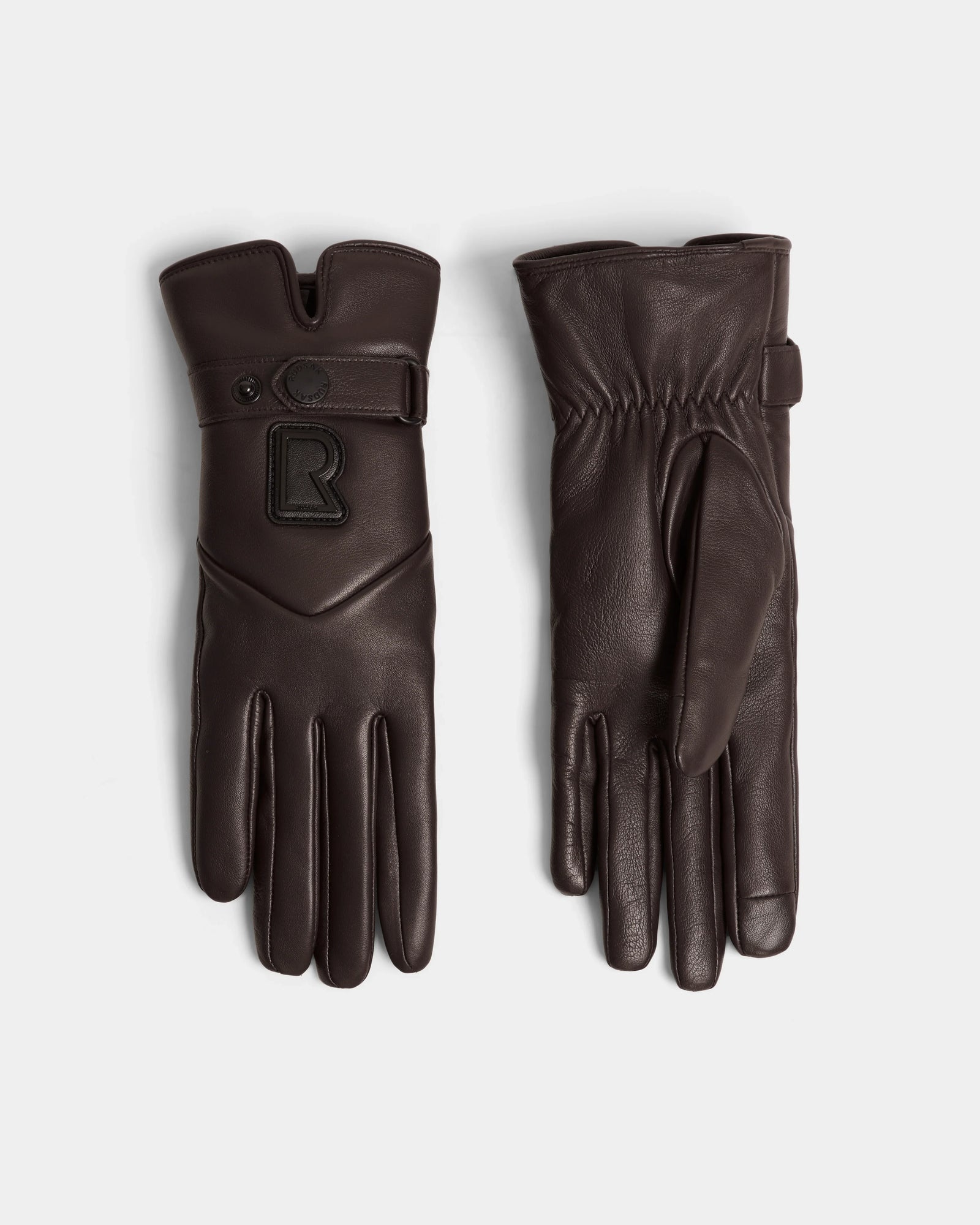 The Rudsak STROMBOLI - 8424510 Espresso gloves feature dark brown leather and cashmere, one showing a gathered palm and the other a snap strap with a raised R logo—stylish womens winter gloves for chilly days.