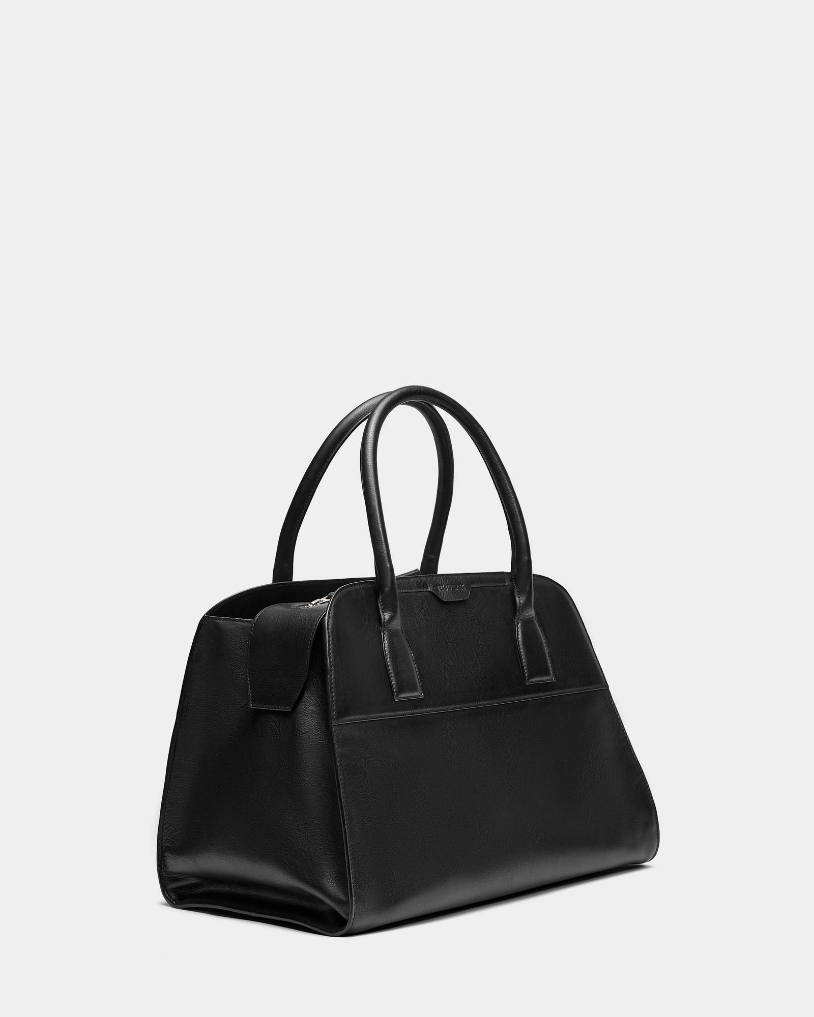 The YASMINA L - 8324516 Black by Rudsak is a black leather tote bag with two rounded handles and a structured rectangular, minimalistic design, shown against a plain light gray background.