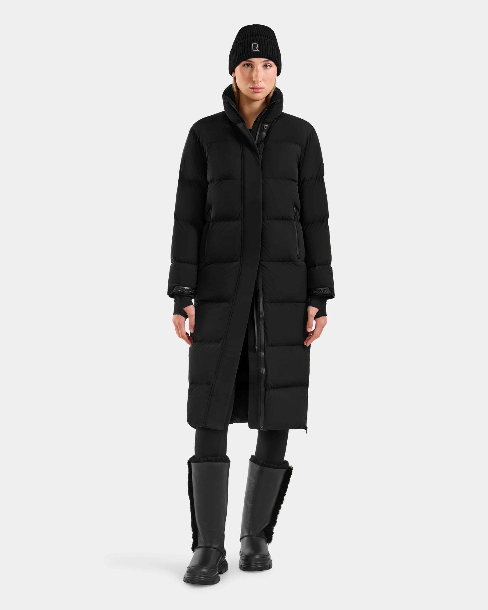 A woman in the Rudsak ALESSANDRA L - L125553 black puffer coat with RDS-certified down quilting.