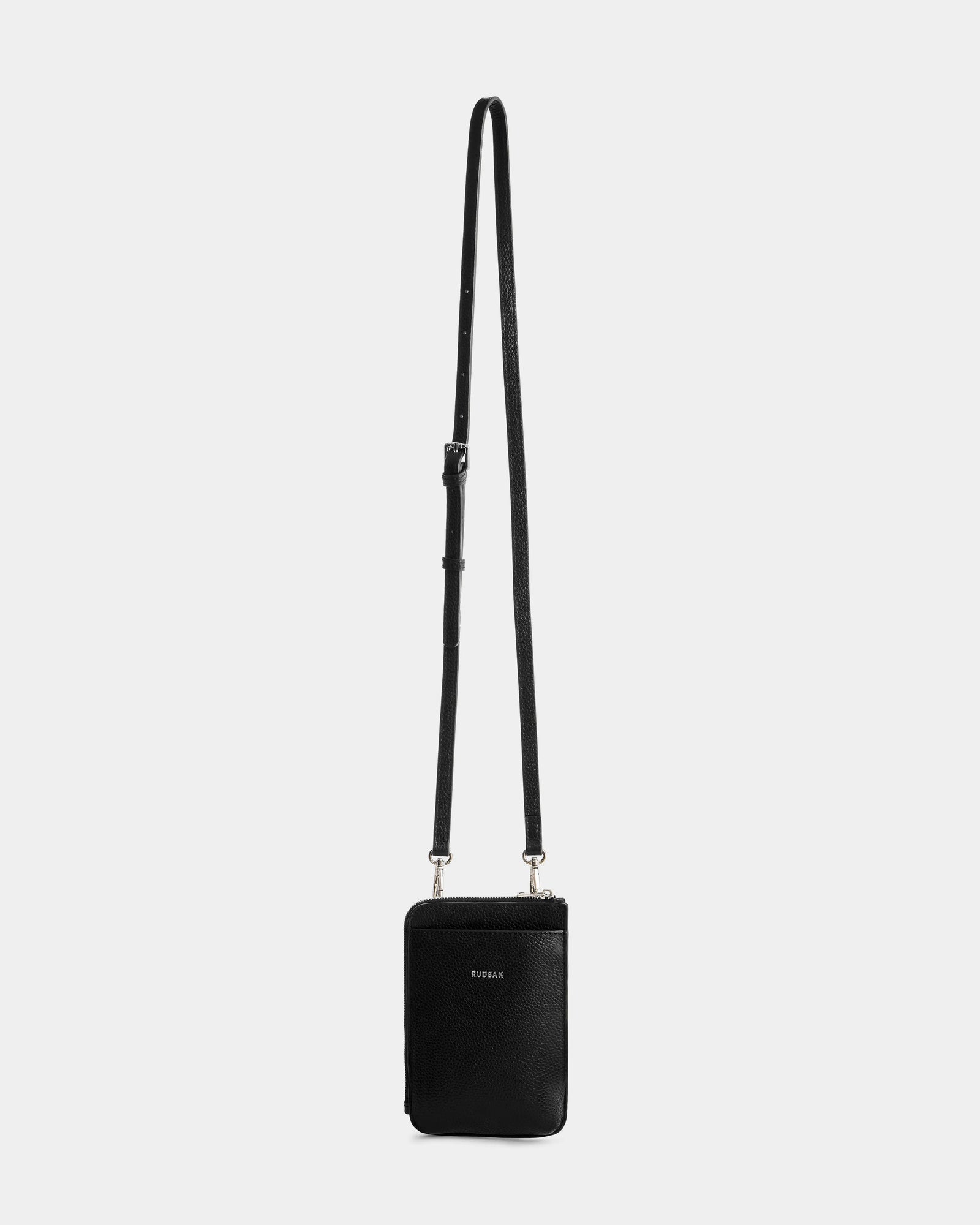 The CELYN - L325514 Black by Rudsak is a sleek, black pebbled leather crossbody with a long adjustable strap and minimal design—an essential everyday bag for women seeking style and function.