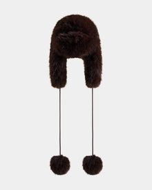 The Rudsak DEMI - L425539 Espresso is a dark brown women’s faux-fur aviator hat with ear flaps and two long strings topped with large fur pom-poms, shown against a plain light background.