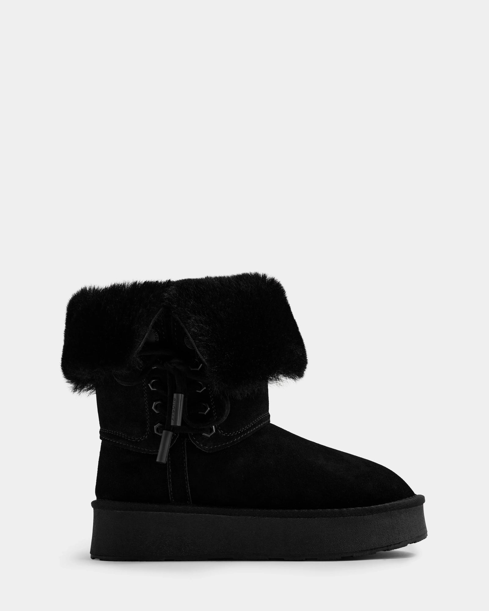 The Rudsak INESA - L225026 Black women’s suede platform boot features a thick sole, lace-up design, and a folded-over faux fur cuff at the ankle, shown against a plain light background.