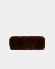 The SANDIE - L425552 Espresso by Rudsak is a rectangular, dark brown fluffy faux fur headband, centered on a plain light gray background—a chic winter accessory for women.