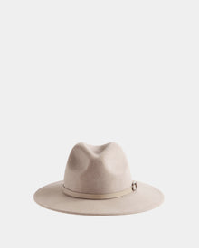 The ZELDA - 8425536 Almond by Rudsak is a light beige women’s wide-brim fedora made from premium felted wool, featuring a matching band with a small buckle, shown on a plain white background.