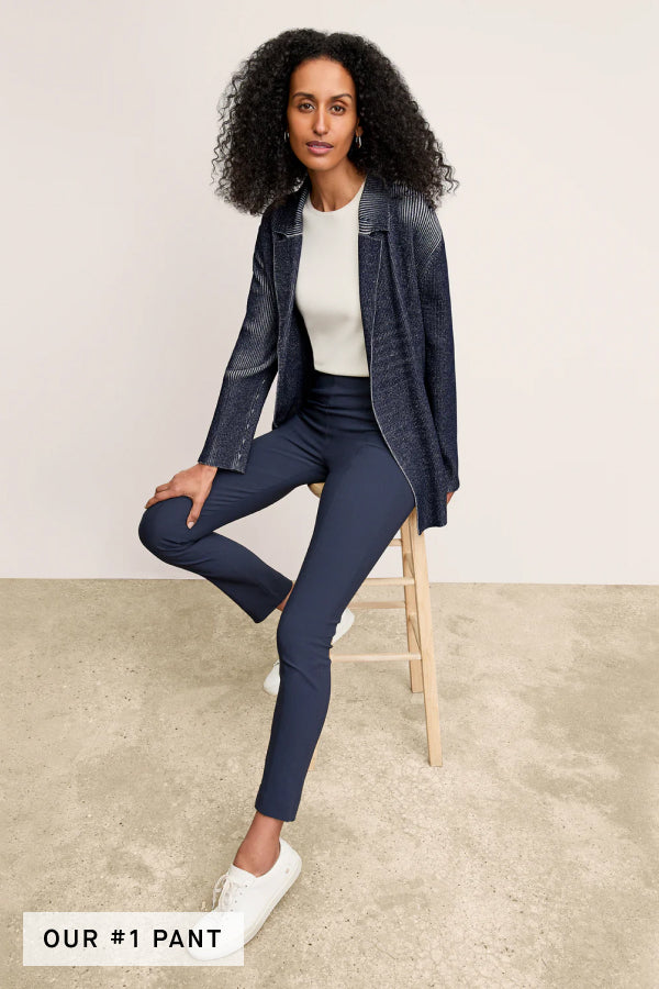 Front image of a woman standing wearing the foster pant in dark navy | Exclude