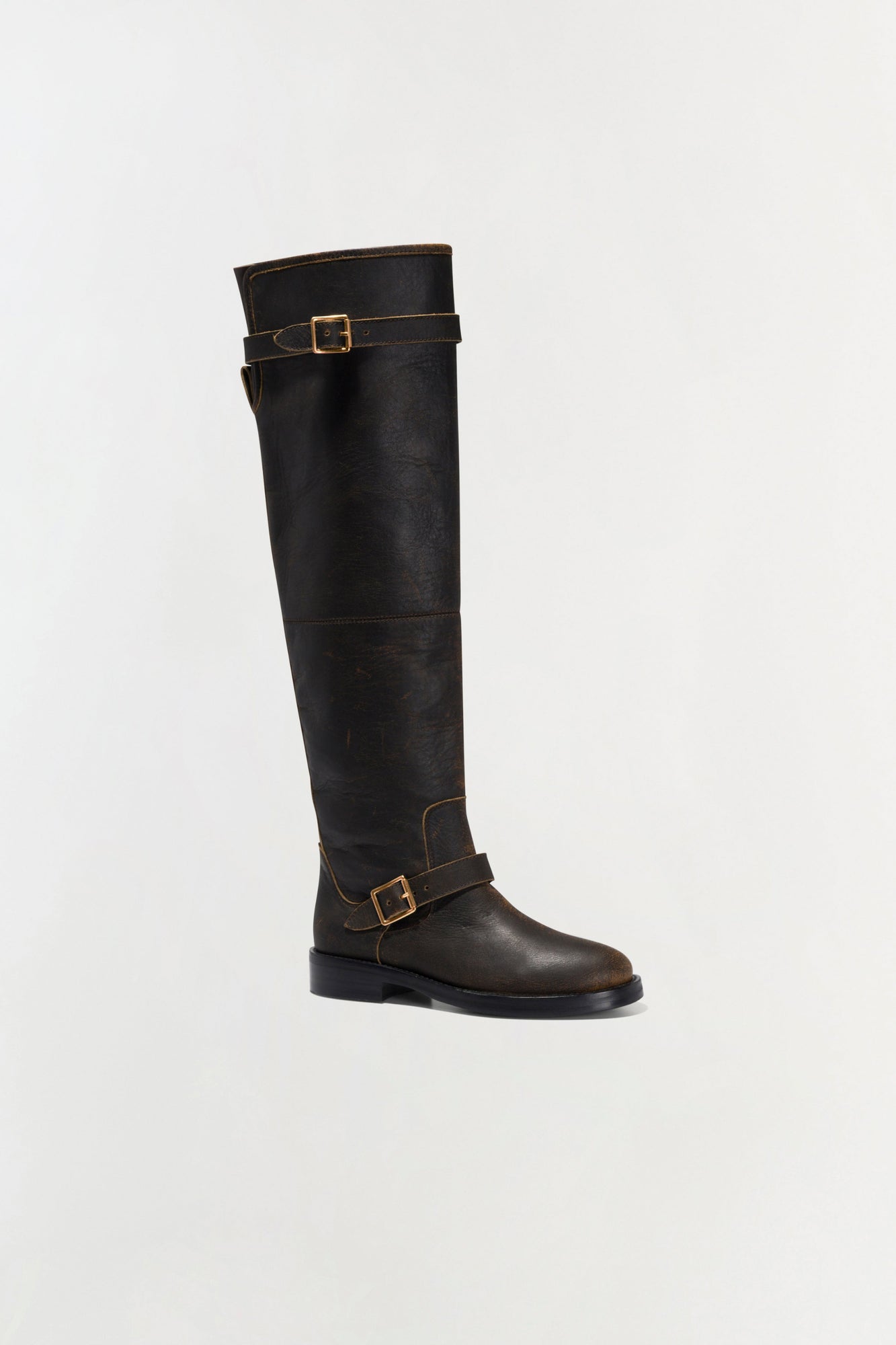 Black leather over-the-knee boot with buckle straps and contrast stitching detail.