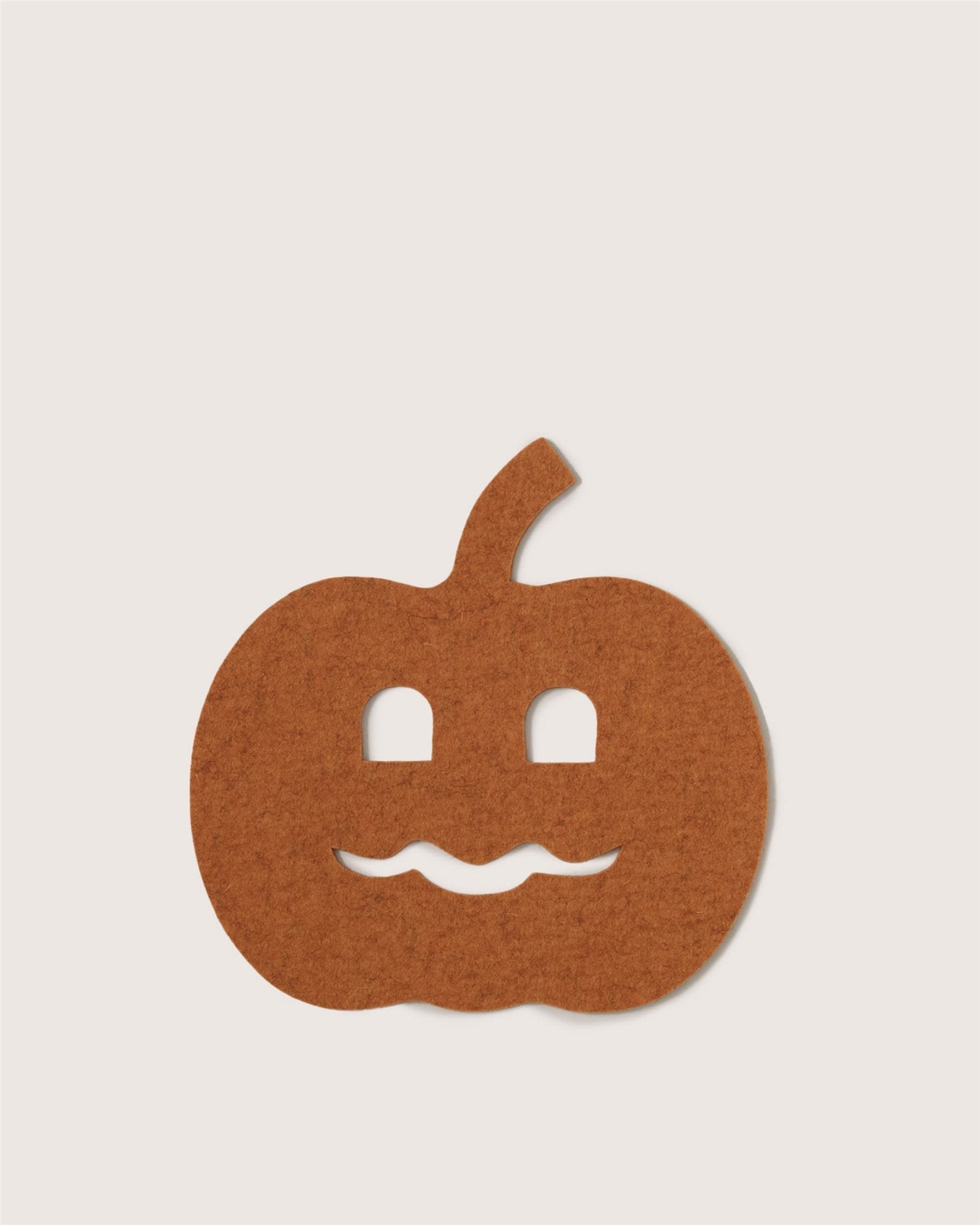 A simple, flat, brown felt pumpkin cutout by Graf Lantz features two square eyes and a wavy jack-o'-lantern mouth on a plain light background.