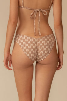 Beige lace bikini bottom with zig-zag stitch pattern and higher coverage cut, shown from back view.