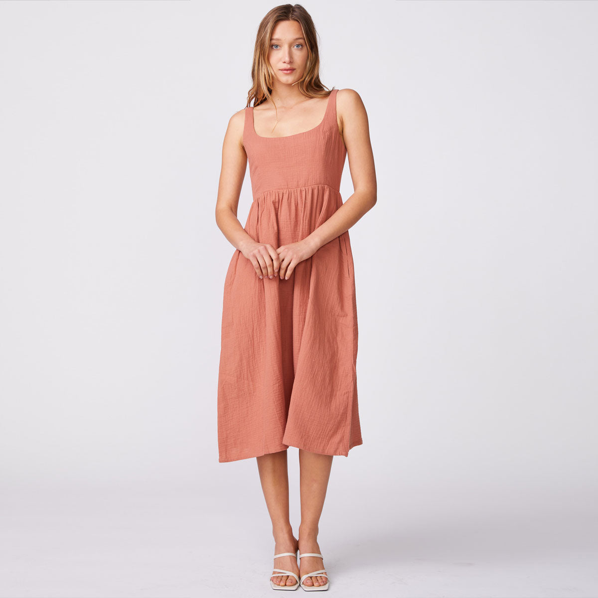 Front view of model wearing the gauze sleeveless maxi dress in faded rust.