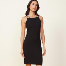 Front view of model wearing the double strap tank dress in black.