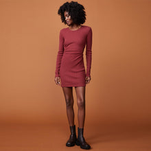 Front view of model wearing the brushed rib cut out dress in rhubarb.