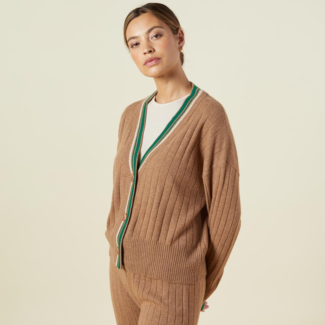 Side view of model wearing the sweater rib oversized cardigan in camel.