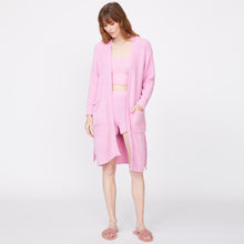 Front view of model wearing the plush sweater robe in orchid.