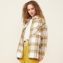 Side view of model wearing the plaid flannel jacket in multi color.