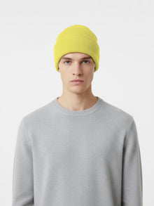 Model wearing a Merino Cuff Beanie in Mineral Yellow