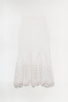 Cream knit midi skirt with embroidered cutout details along the hem.