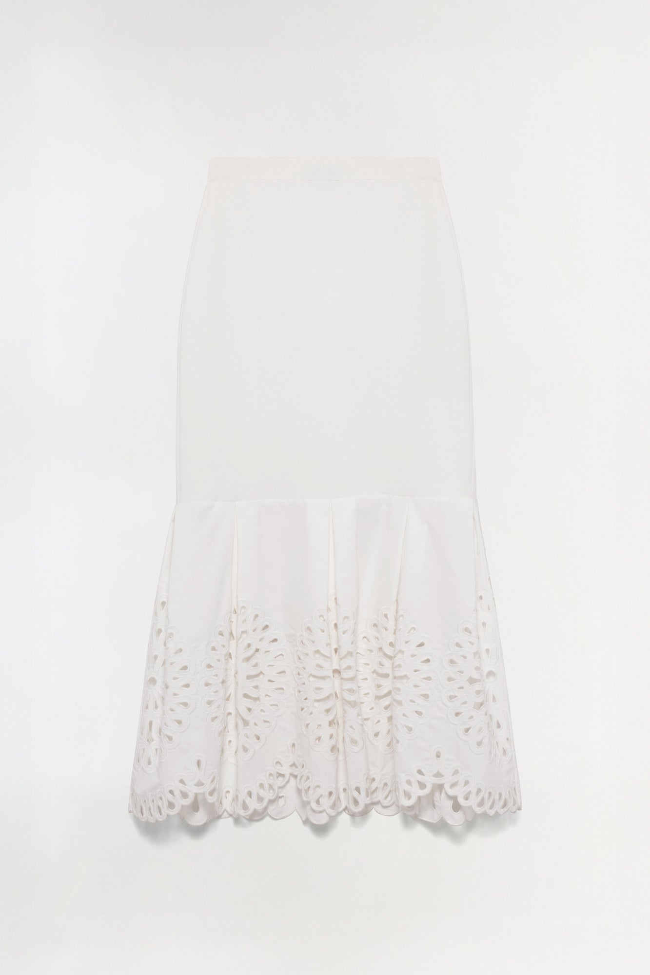 Cream knit midi skirt with embroidered cutout details along the hem.