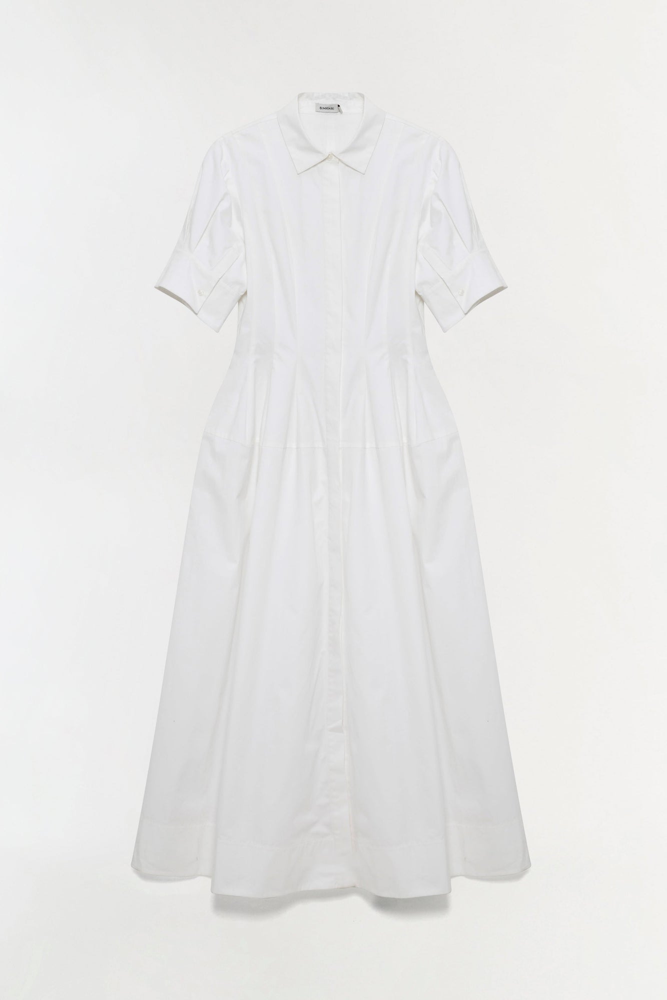 White cotton shirt dress with collared neckline, short sleeves, and full skirt with button front closure.