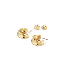 Small Hidden Heart Hoop Earrings in Gold Laying Flat on White Background