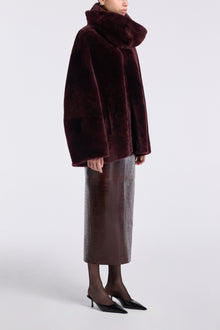 Model is wearing Nour Hammour Lodge Decadent Shearling Pull Cassis - Three Quarters