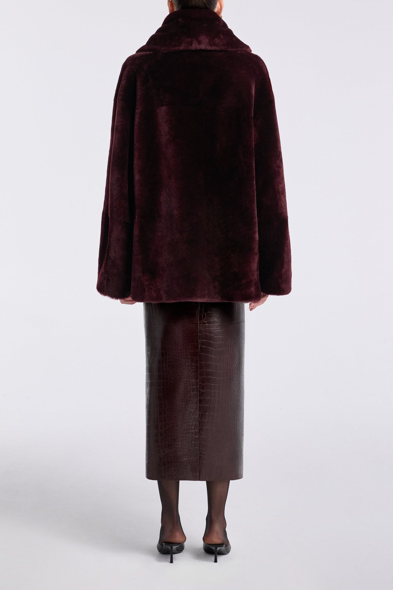 Model is wearing Nour Hammour Lodge Decadent Shearling Pull Cassis - Back