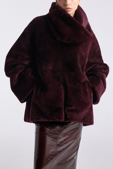 Model is wearing Nour Hammour Lodge Decadent Shearling Pull Cassis - Close Up
