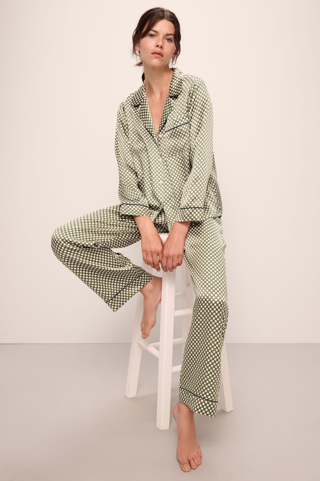 Model is wearing Inez Washable Silk Printed Long PJ Set in Geo Sphere Moss/Navy.
