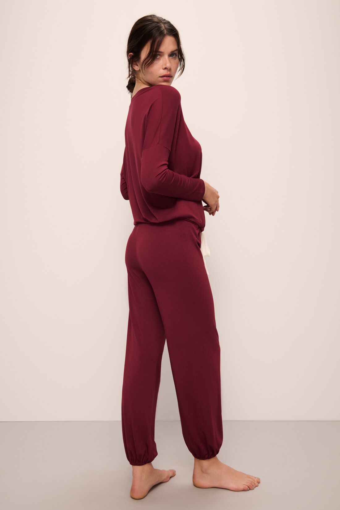 Model wears Gisele TENCELâ„¢ Modal Slouchy PJ Set in Cabernet/Ivory.
