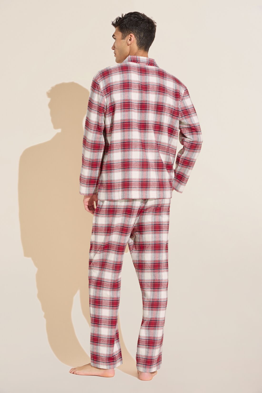 Model wears Mens Flannel Long PJ Set in red and ivory plaid.