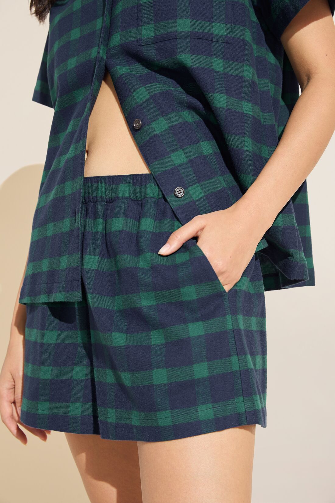 Model wears Flannel Short PJ Set in Navy and Green plaid.