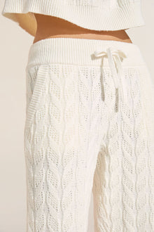 Model wears Cable Knit Recycled Sweater Straight Leg Pant in Ivory.